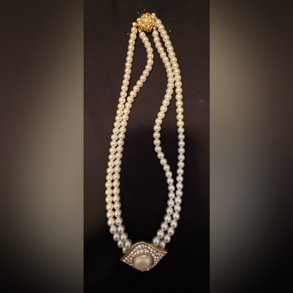 Elegant double strand pearl necklace with statement pendant with large pearl.